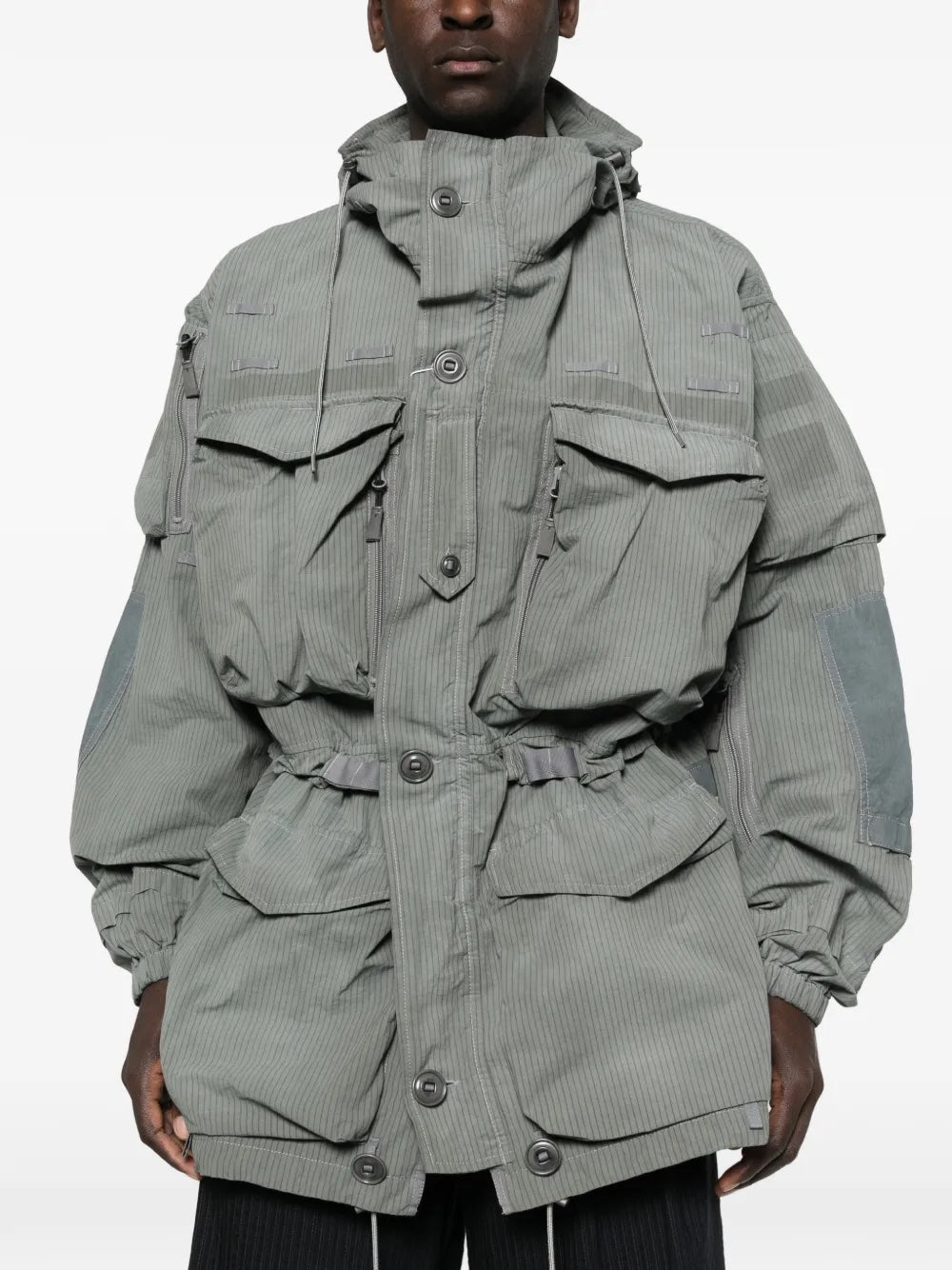 Close-up, front view of a model wearing the Men's Sports Jacket in Sage from Maison Margiela