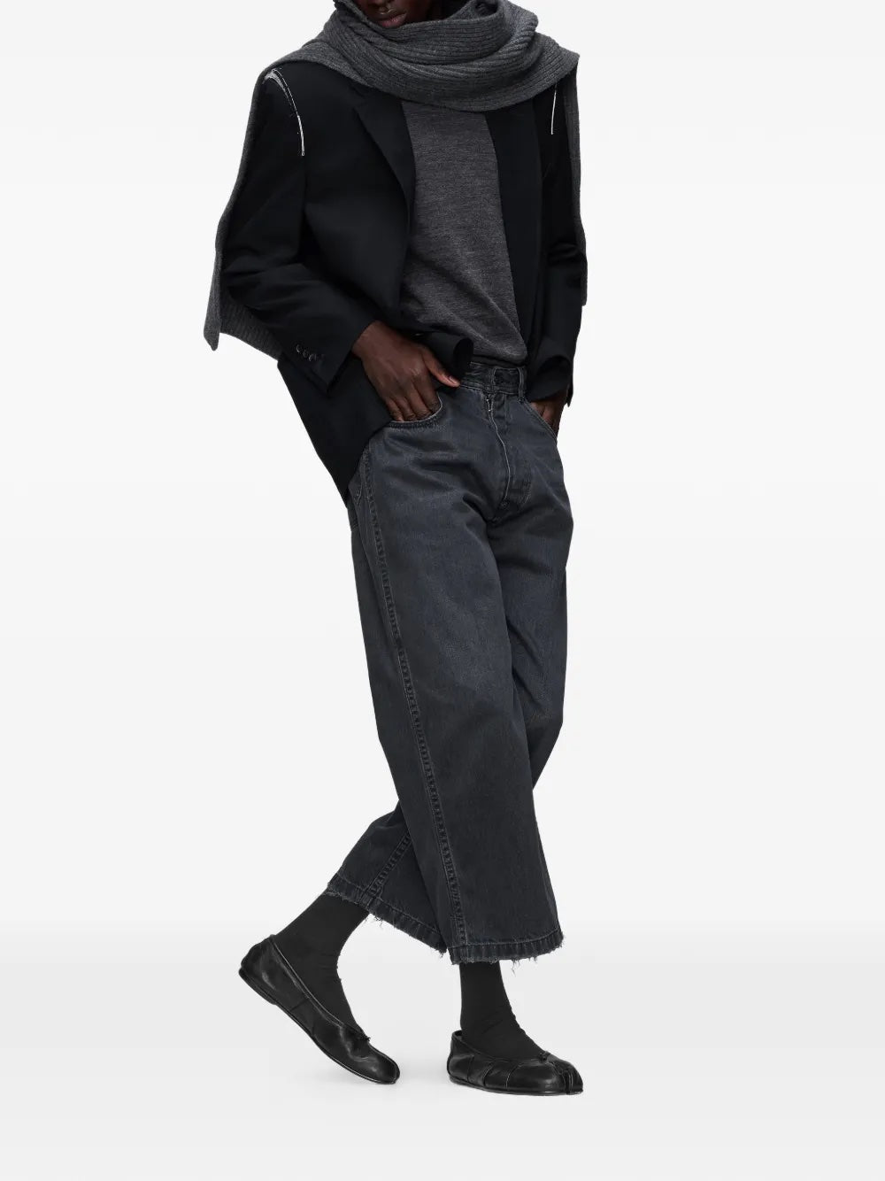Model wearing the black washed denim jeans from Maison Margiela