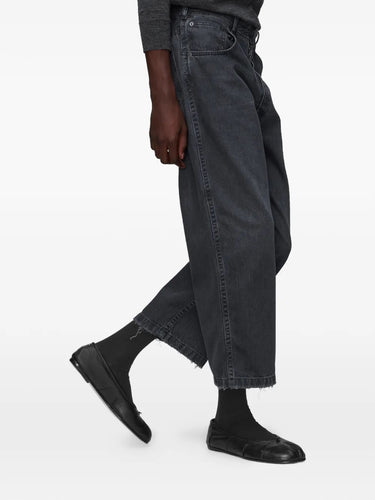 Close-up of model wearing the black washed denim jeans from Maison Margiela 