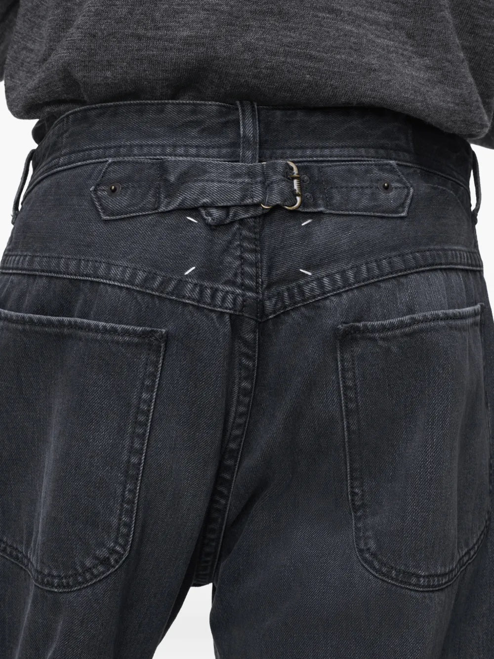 Close-up of the buckle detail on the black washed denim jeans from Maison Margiela 