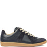 Dark navy blue leather sneakers with panel design and rubber soles on a white background