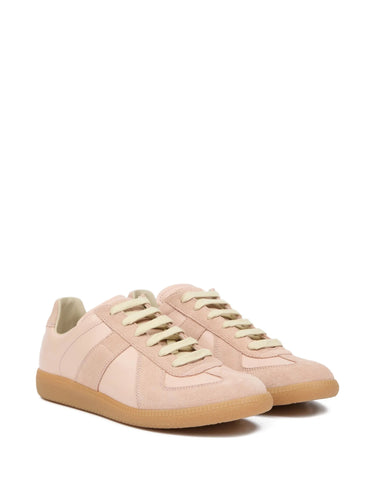 A pair of soft pink leather sneakers with panel design from Maison Margiela on a white background