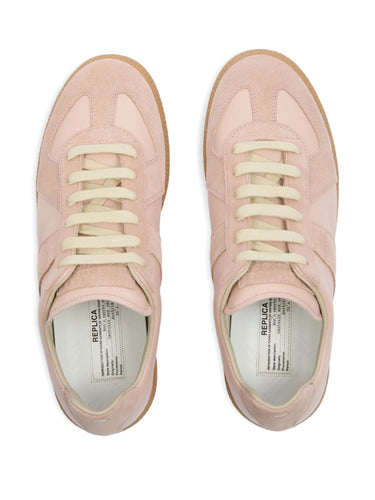Top view of soft pink leather sneakers from Maison Margiela on a white background