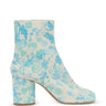 Maison Margiela Tabi Ankle Boot 80mm in white and light blue, side view showing split-toe silhouette and cylindrical block heel in floral-printed suede