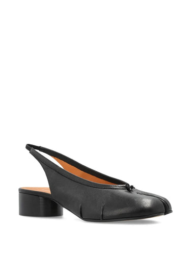 Diagonal angled view of the black Tabi New Ballerina Slingback 30mm, showing the bow detail at the front, pleated sides, and signature split-toe silhouette.