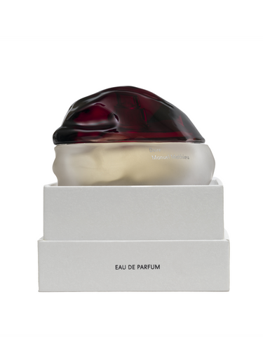 Eau de Parfum bottle with a white box on a white background