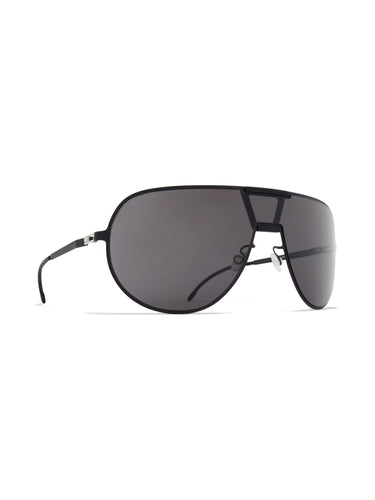 Aviator Sunshield MR005 in Black/Pitch Black Super Black by Mykita x Rimowa, angled front view showing oversized shield lens, ultra-thin black stainless steel frame and integrated nose bridge detail