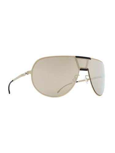 Aviator Sunshield MR005 in Titan/Pitch Black Electrum Mirror by Mykita x Rimowa, angled view showing contoured shield lens silhouette, gold-tone titan frame, geometric Mylon clip detail and electrum mirror lens finish