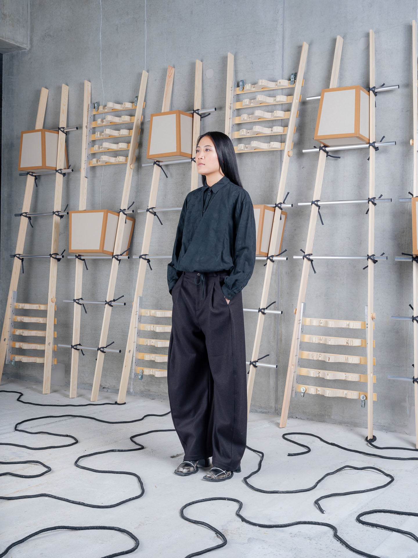 Model wearing One Pants in Black by Henrik Vibskov three-quarter view
