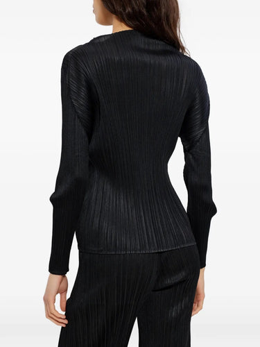Back view of model wearing the black pleated mock neck top with long sleeves from Pleats Please Issey Miyake on a white background