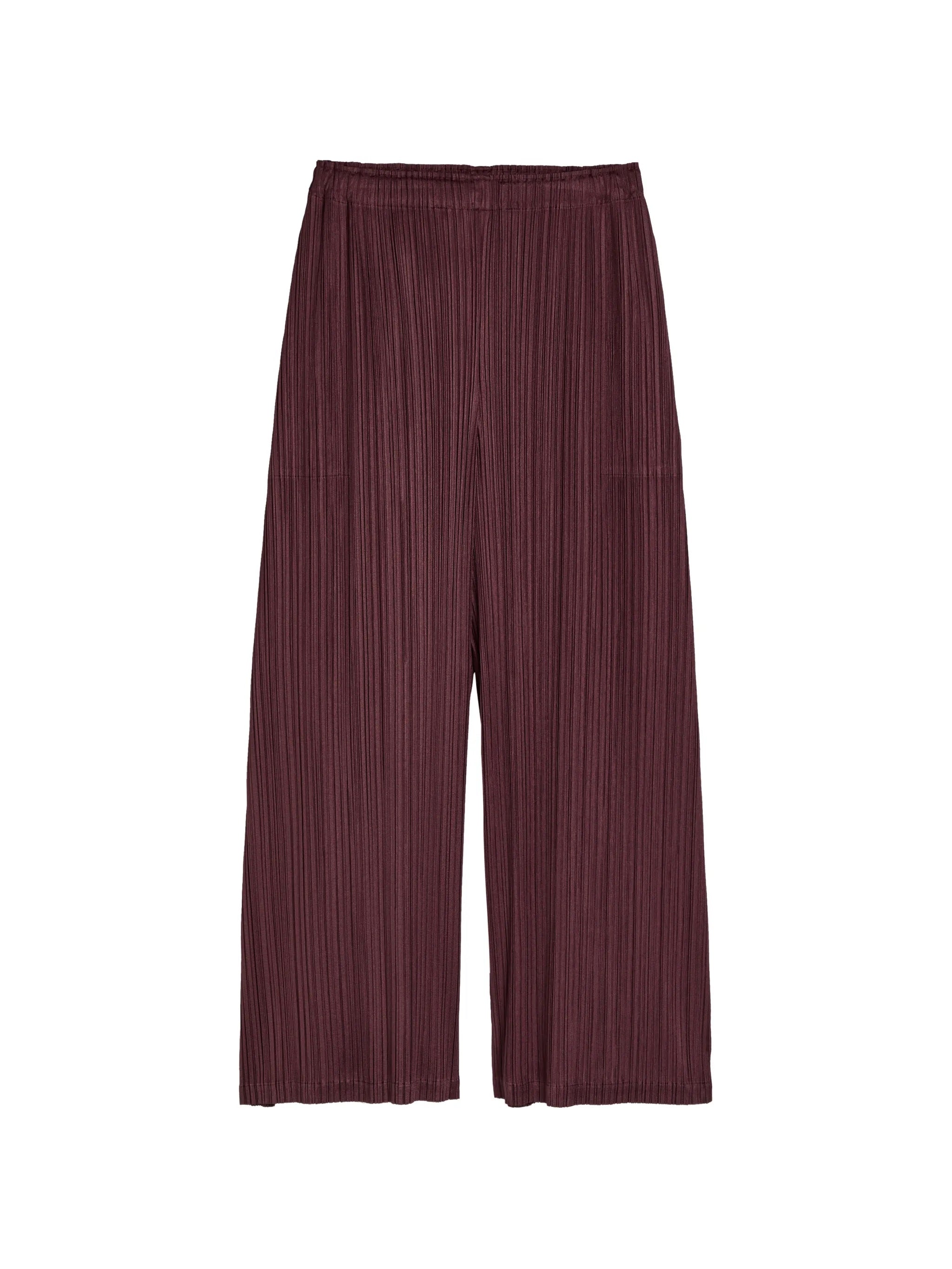 Bordeaux pleated pants from Pleats Please Issey Miyake on a white background