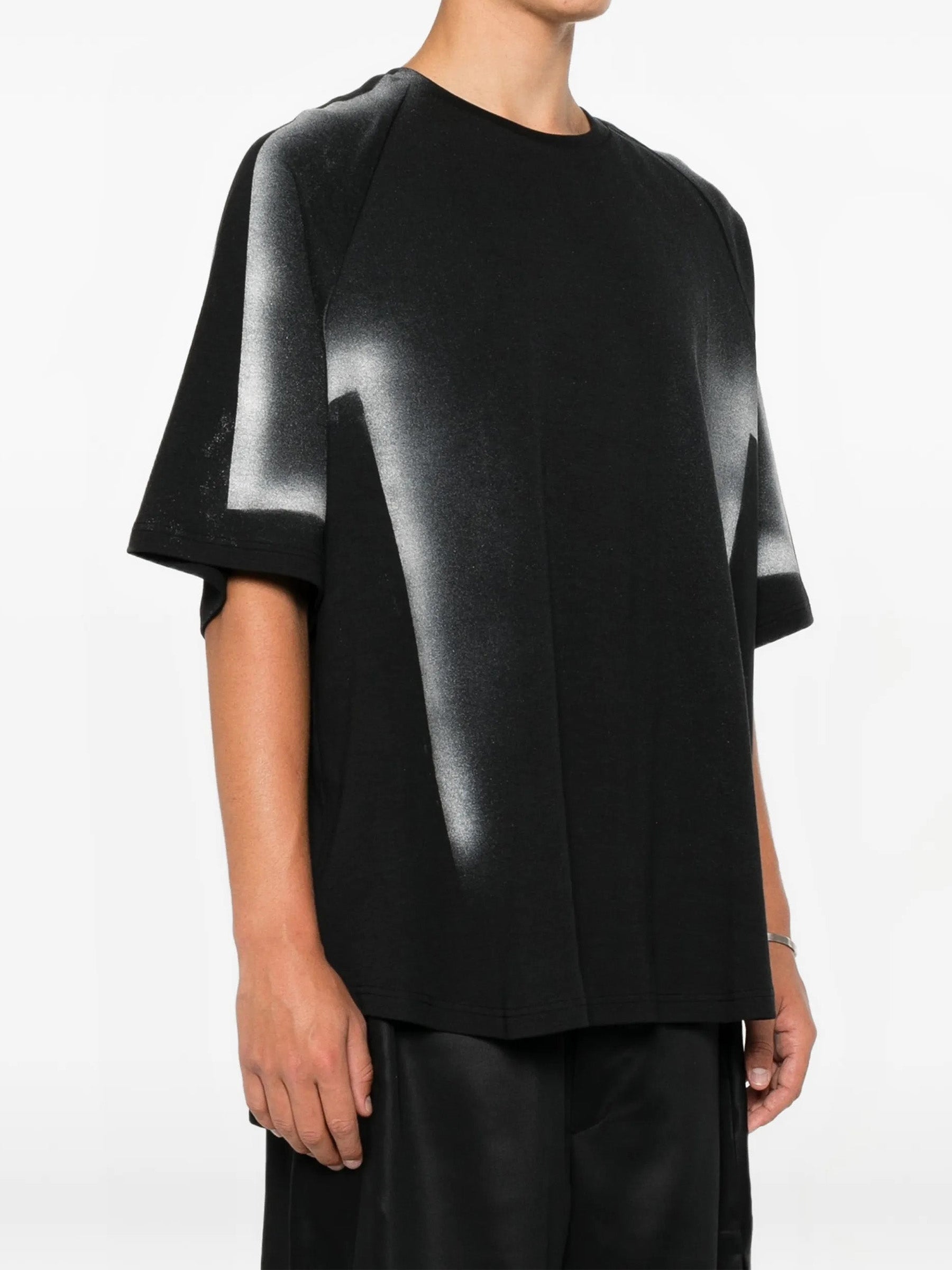 House Of The Very Islands Rae T-Shirt in Black Iridescent Print - front view on model showing round neck and iridescent print detail