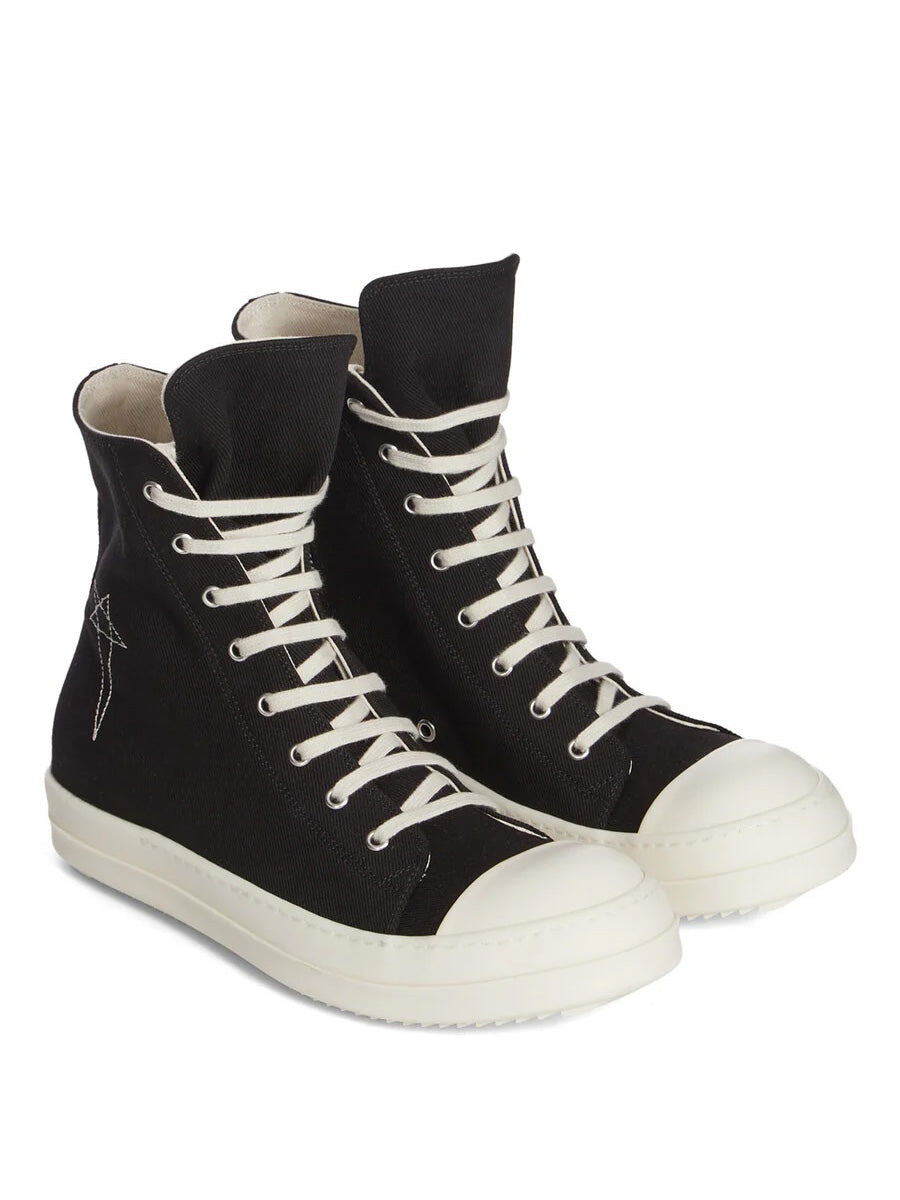 Angled view of Rick Owens DRKSHDW AW26 Sneaks in black canvas with milk white toe caps, lace-up front and ridged rubber sole