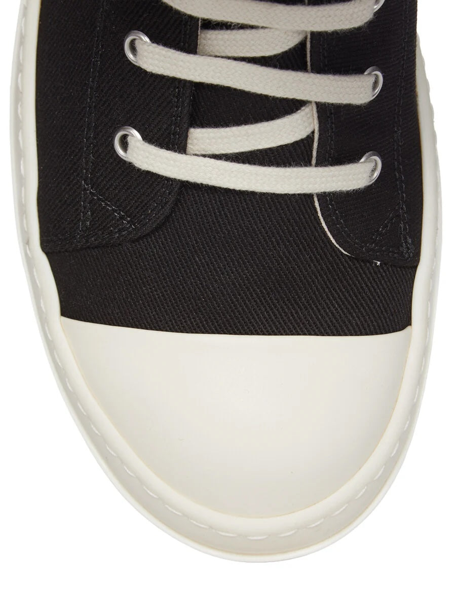 Close-up of Rick Owens DRKSHDW AW26 Sneaks showing milk white rubber toe cap, black canvas upper, cream laces and stitched sole detail
