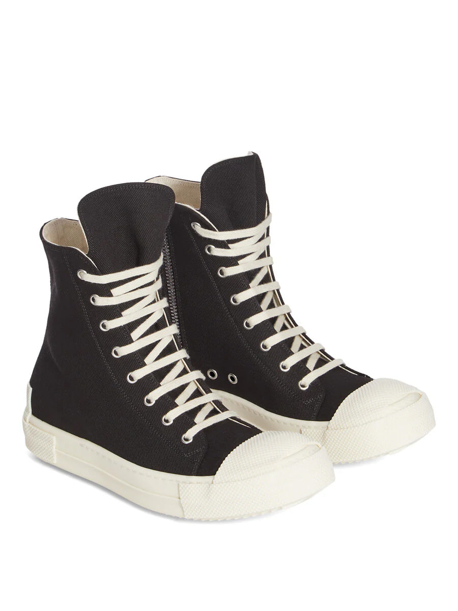 Angled view of Rick Owens DRKSHDW Tower Sneaks in Black Overdyed Denim with black canvas upper, milk white laces, extended textured toe caps and sculptural heel detail