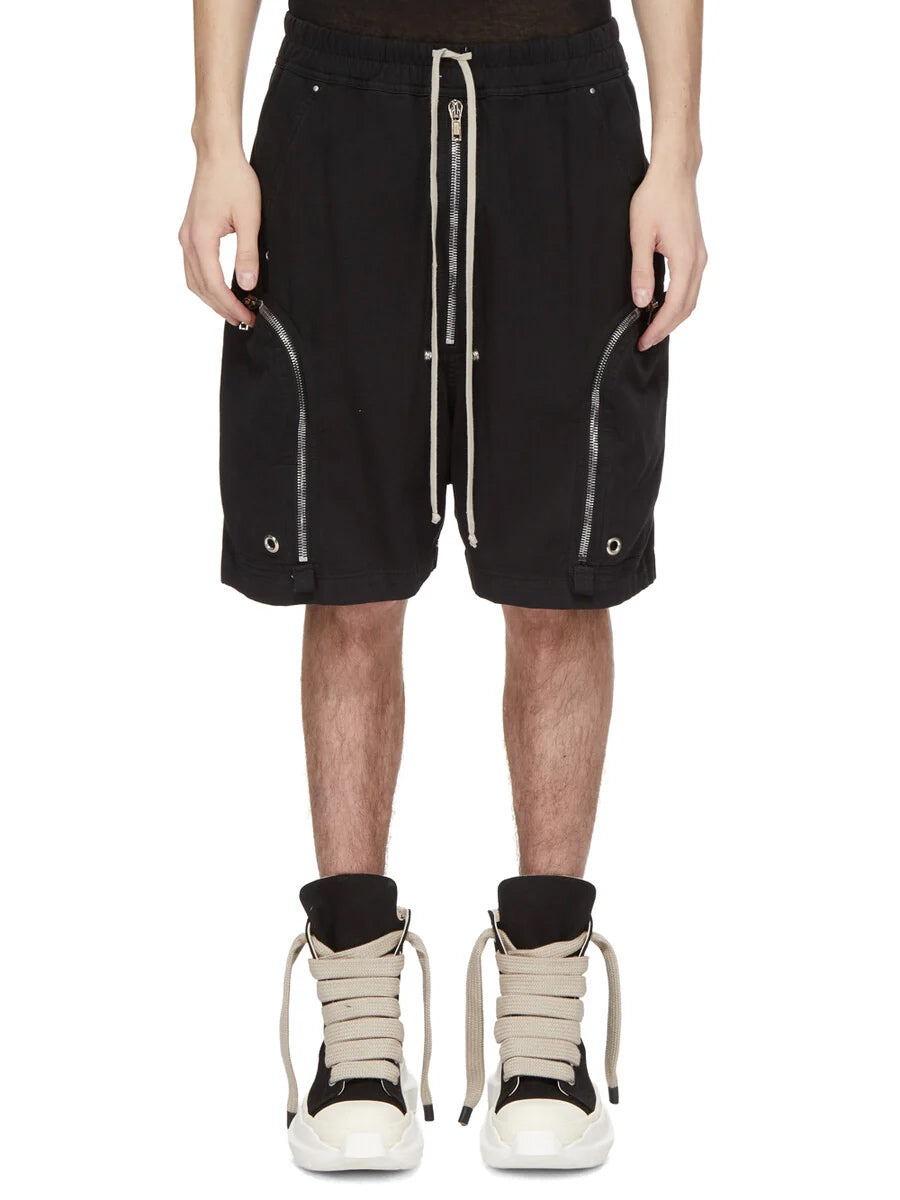 Rick Owens DRKSHDW Bauhaus Drawstring Shorts in Black worn from the front, showing the knee-length relaxed silhouette and curved zip pocket construction.