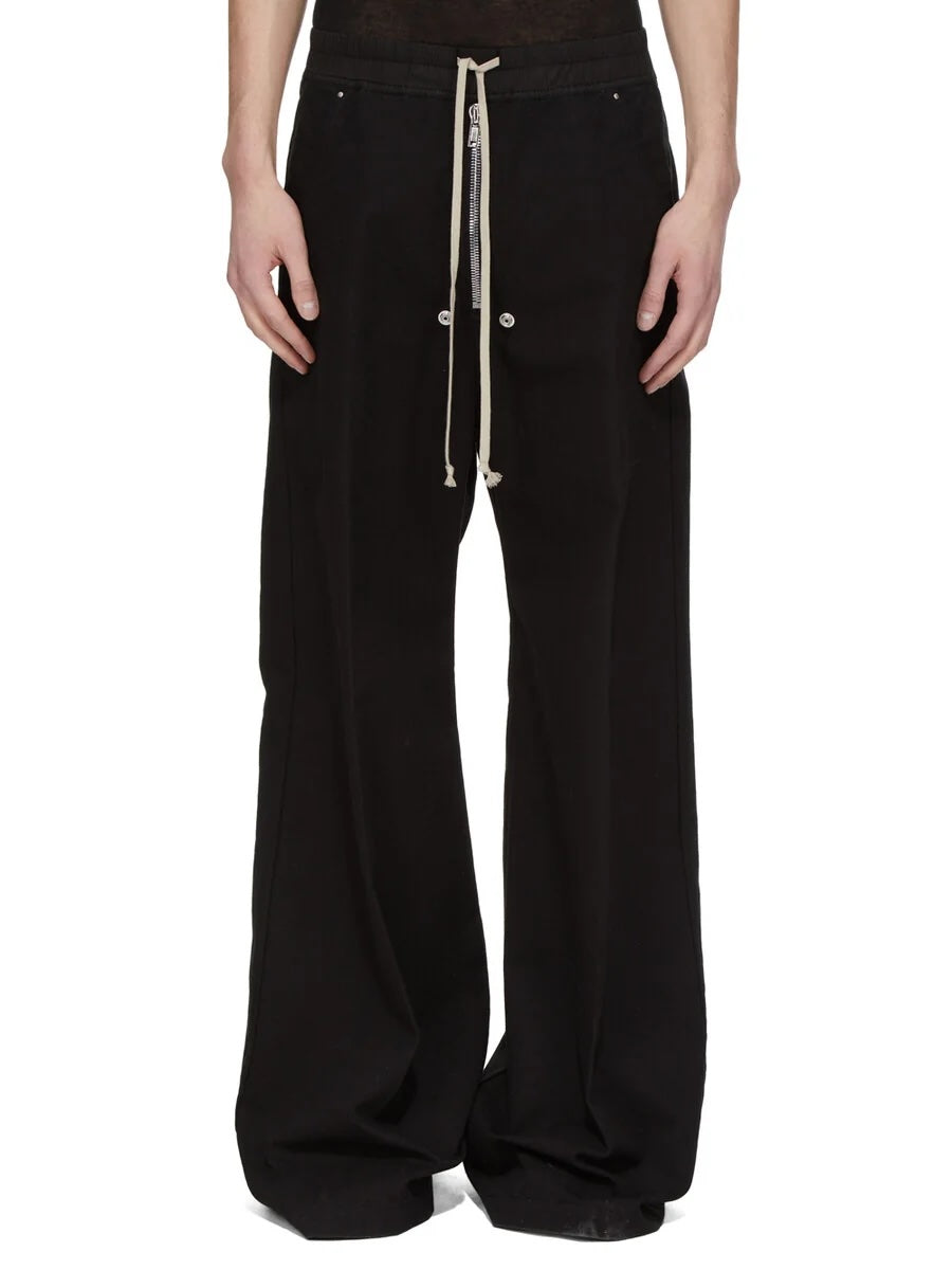 Rick Owens DRKSHDW Geth Belas in black shown on model from the front with a low crotch, wide leg, cream drawstring and exposed centre zipper.