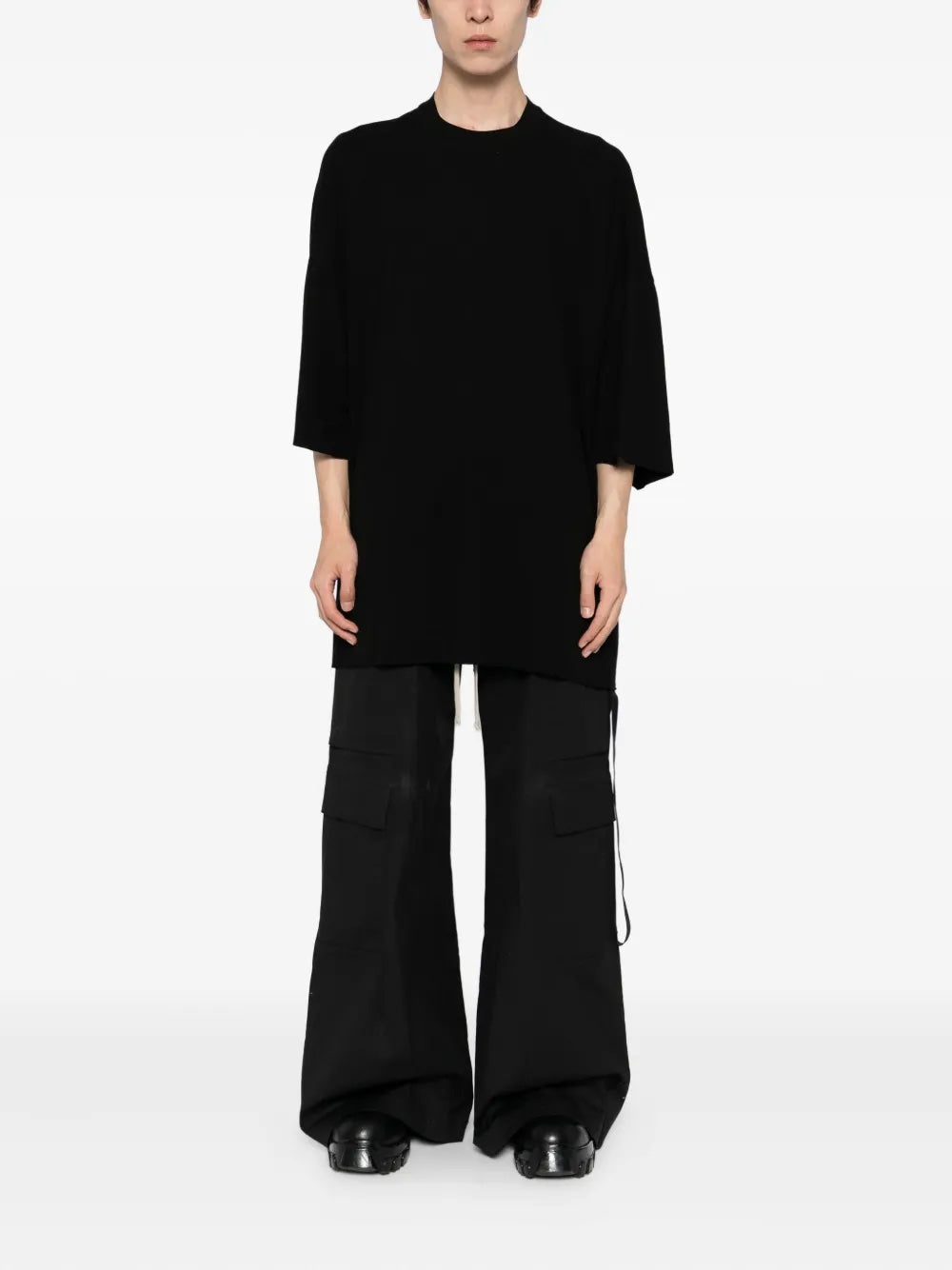 Person wearing a black outfit on a white background