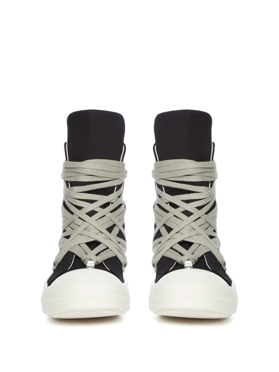 Front view of Rick Owens DRKSHDW Megalace Sneaks in Black Overdyed Denim with oversized pale grey wraparound laces, black high-top silhouette and milk white toe caps