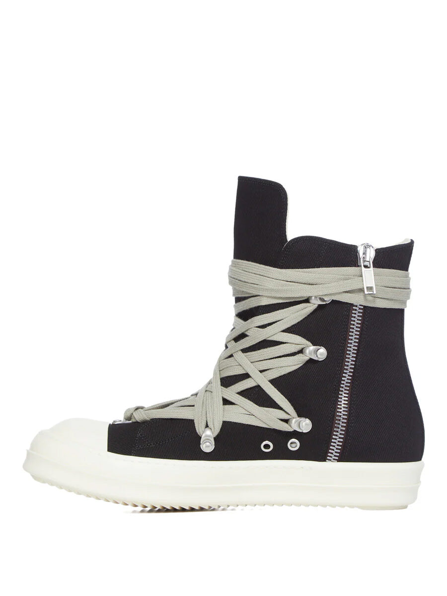 Side view of Rick Owens DRKSHDW Megalace Sneaks in Black Overdyed Denim showing wraparound megalace fastening, silver side zip and milk white sole
