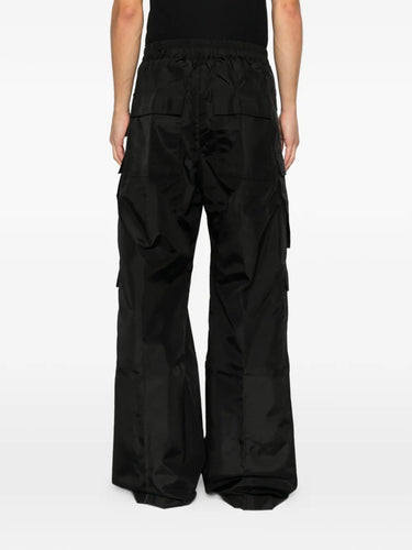 Back view of black cargo pants with long drawstrings from Rick Owens DRKSHDW on a white background