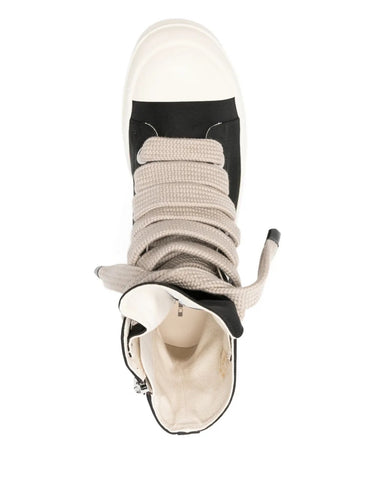 Top view of black high-top sneakers with jumbo laces from Rick Owens on a white background
