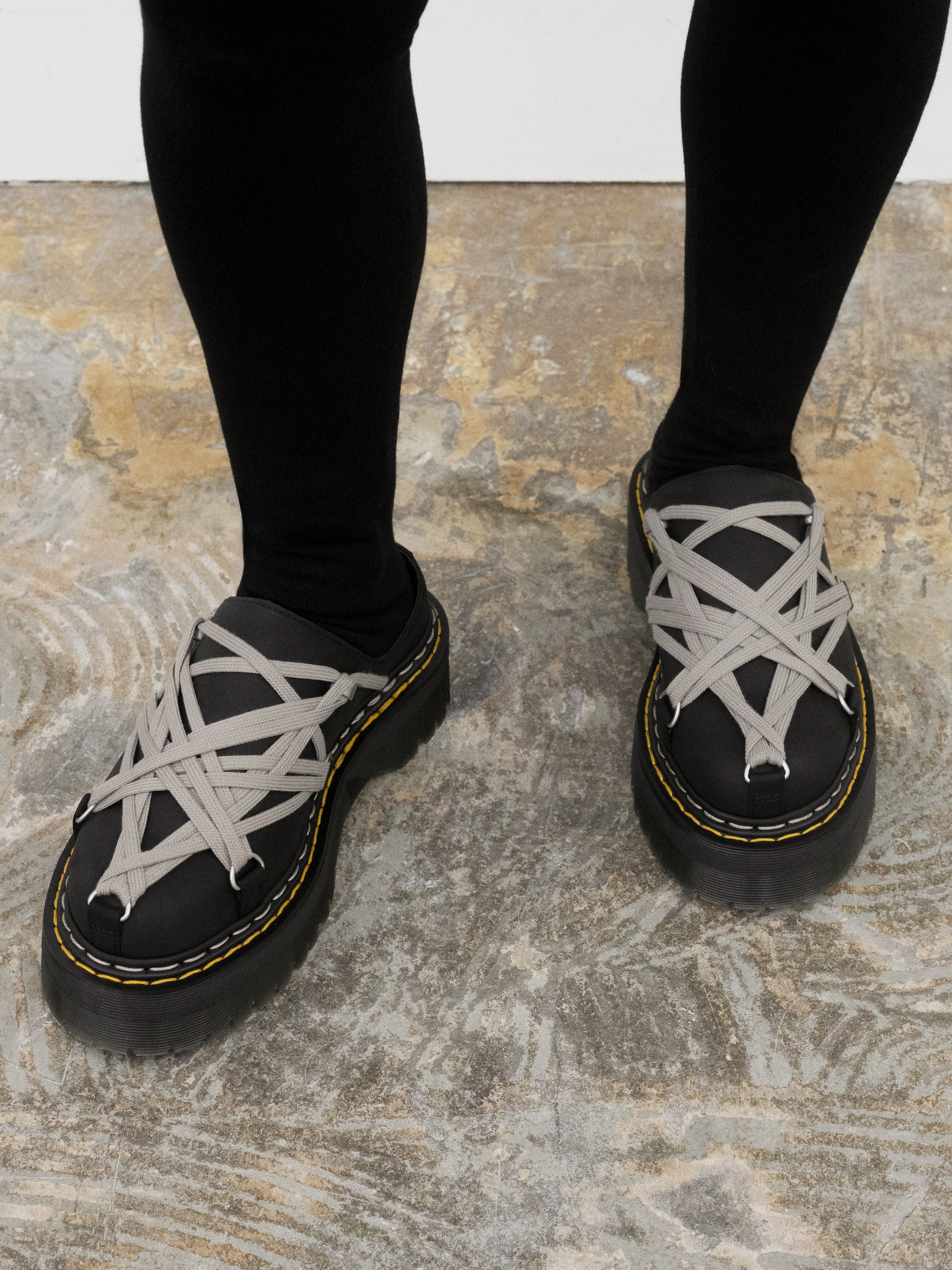 Rick Owens x Dr. Martens black Megalace® mules worn on foot, showing the open-back shape, pearl lacing and Quad soles.