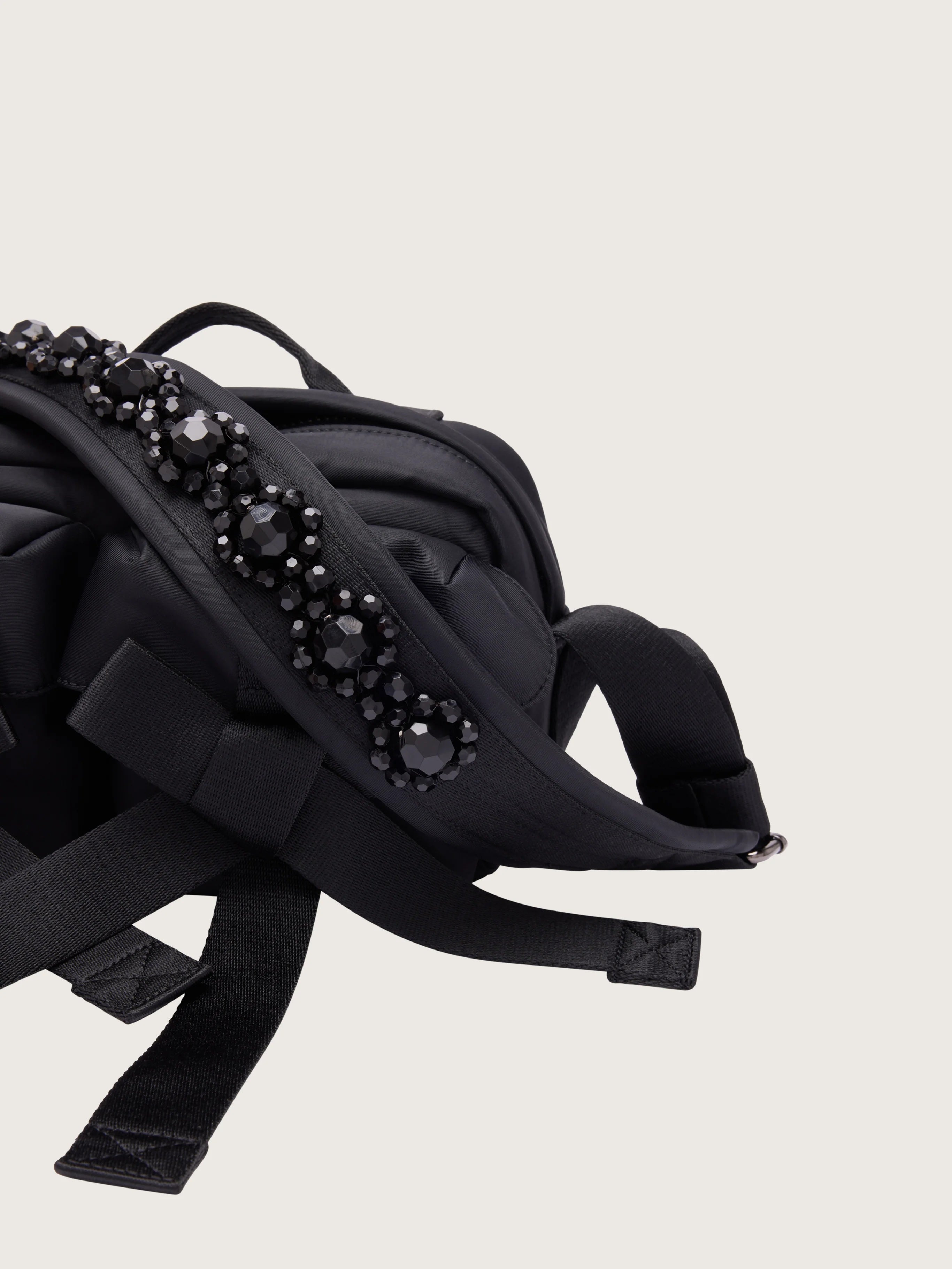 Detail view of Simone Rocha Beaded Classic Bow Crossbody Bag in Black, showing the black beaded shoulder strap, padded body and oversized bow detailing.