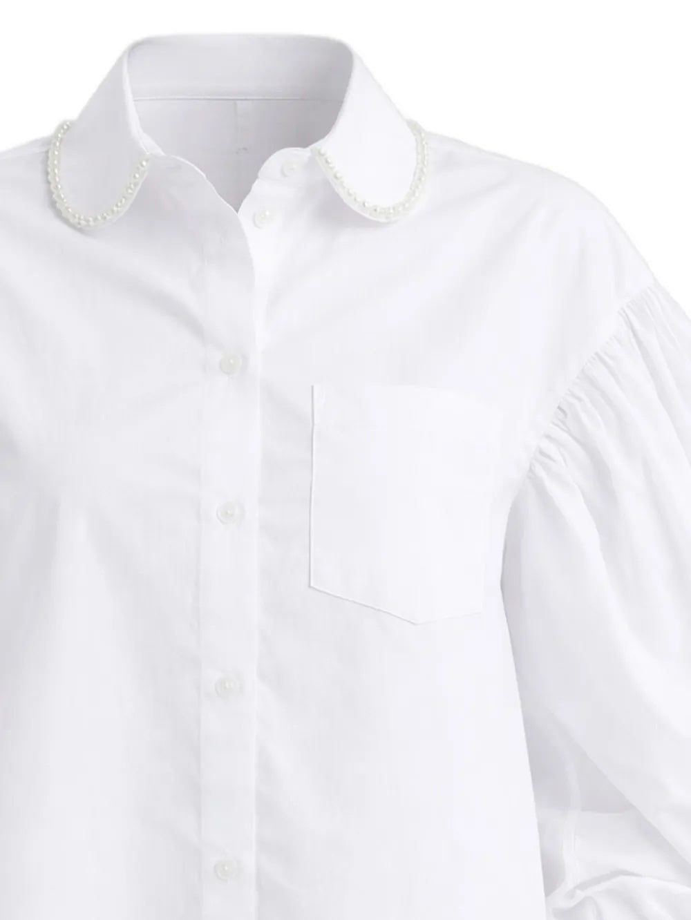 Close-up of the white shirt from Simona Rocha with pearl details on collar