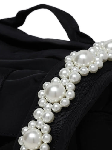 Pearl detail on bag shoulder strap
