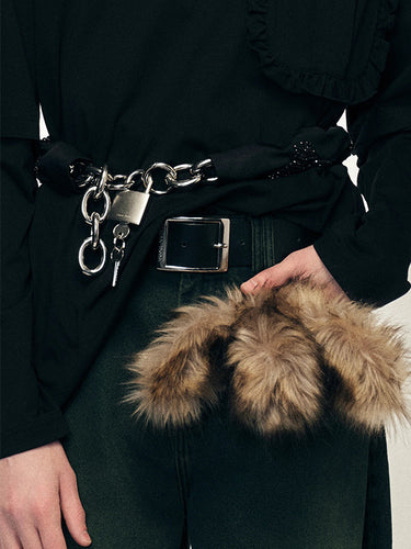 Person wearing a black outfit with a belt and fur coin purse.