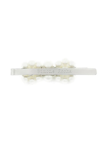 Silver barrette with floral design on a white background