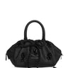 Black handbag from Simone Rocha with floral embellishments on a white background
