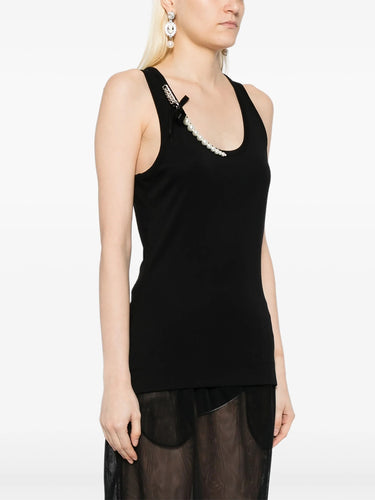 Black sleeveless top with sheer overlay worn by a model on a white background