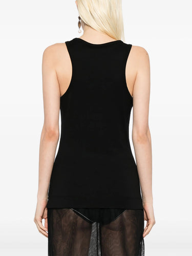 Black sleeveless top worn by a person on a white background