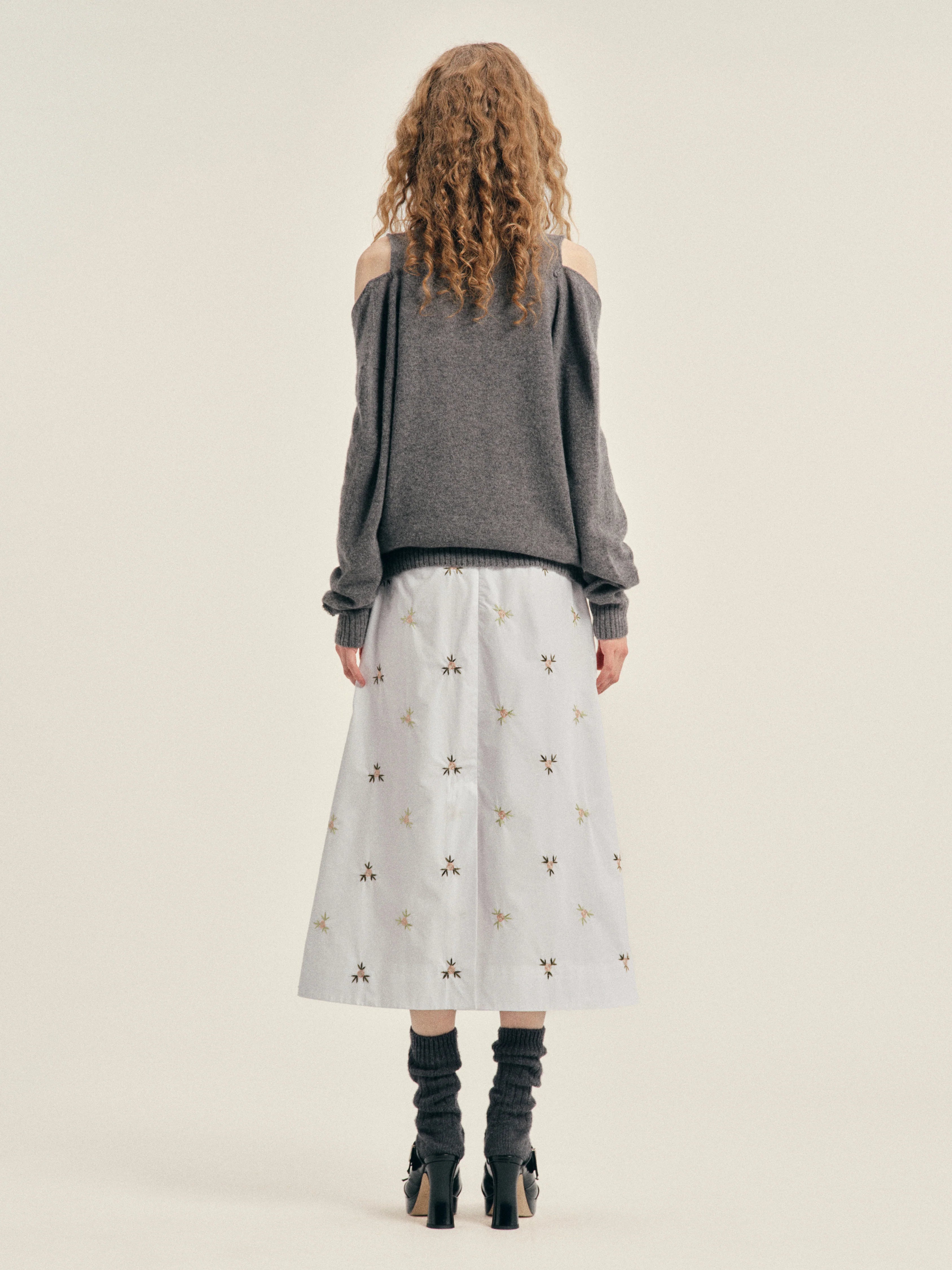 Simone Rocha Relaxed Cashmere Slash V-Neck Jumper With Embellishment in Grey, worn back view showing the relaxed fit and cold-shoulder sleeve construction.