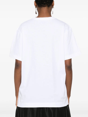 Person wearing a plain white t-shirt on a white background