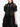 A person wearing a sheer black cropped shirt with puffy sleeves from Simone Rocha