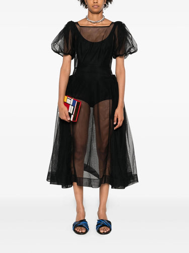 Black sheer dress worn by a model on a white background