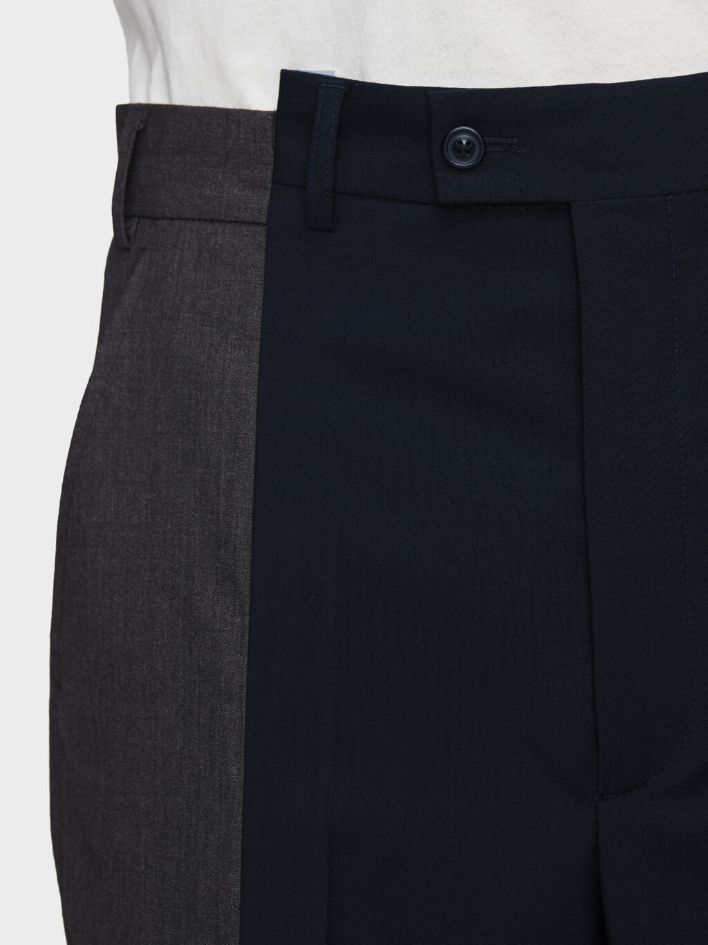Close-up of the contrasting spliced panel construction on Maison Margiela Spliced Tailored Trousers