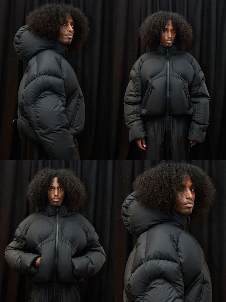 Stamm Exchange Anyone Puffer in Black shown in a four-panel image with front, side and close-up views, highlighting the oversized quilted sleeves, cropped padded silhouette, high collar and padded hood.