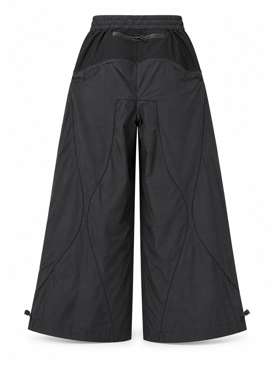 Stamm Exchange Center Black Pants in Black, front view with elasticated waistband, zipped pockets, curved panel seams and vertical STAMM logo detail.