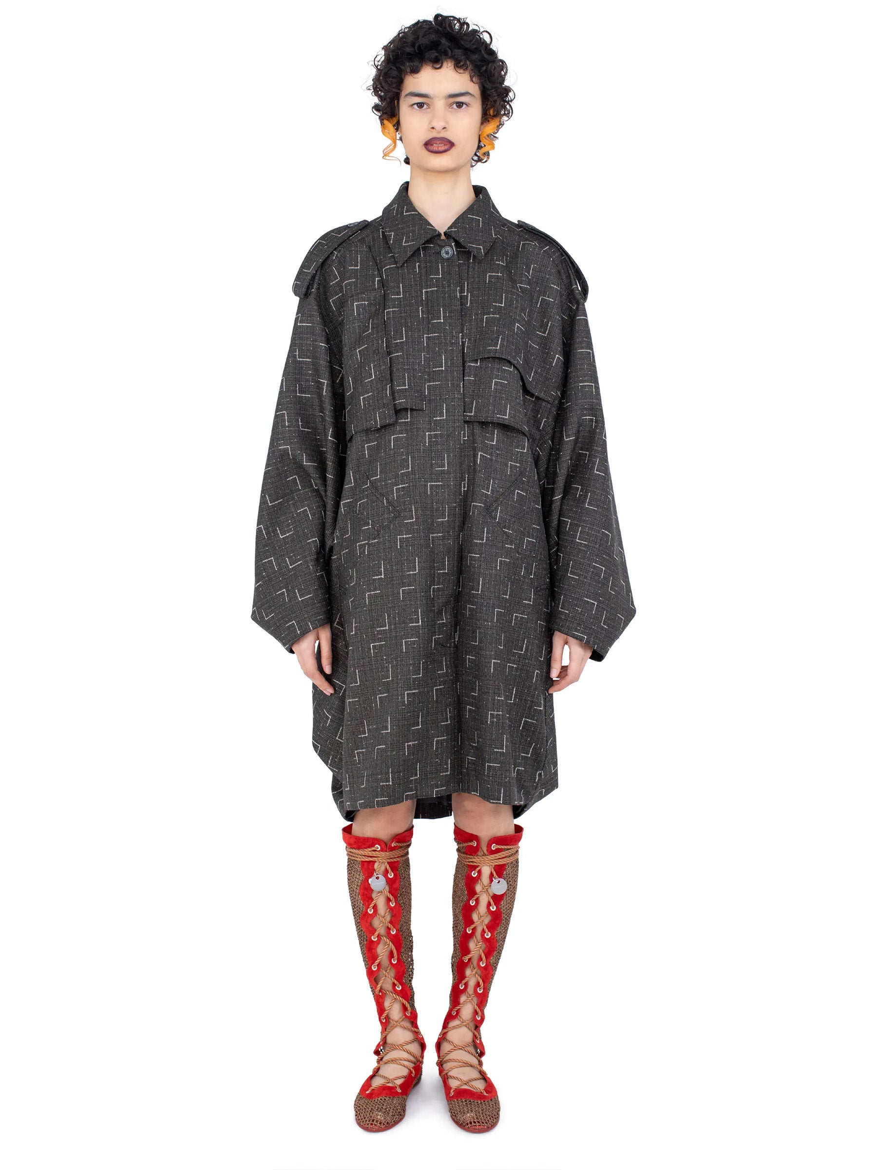  Model wearing the Kiko Kostadinov Statsinger Coat in Off Black & Chalk from the front.