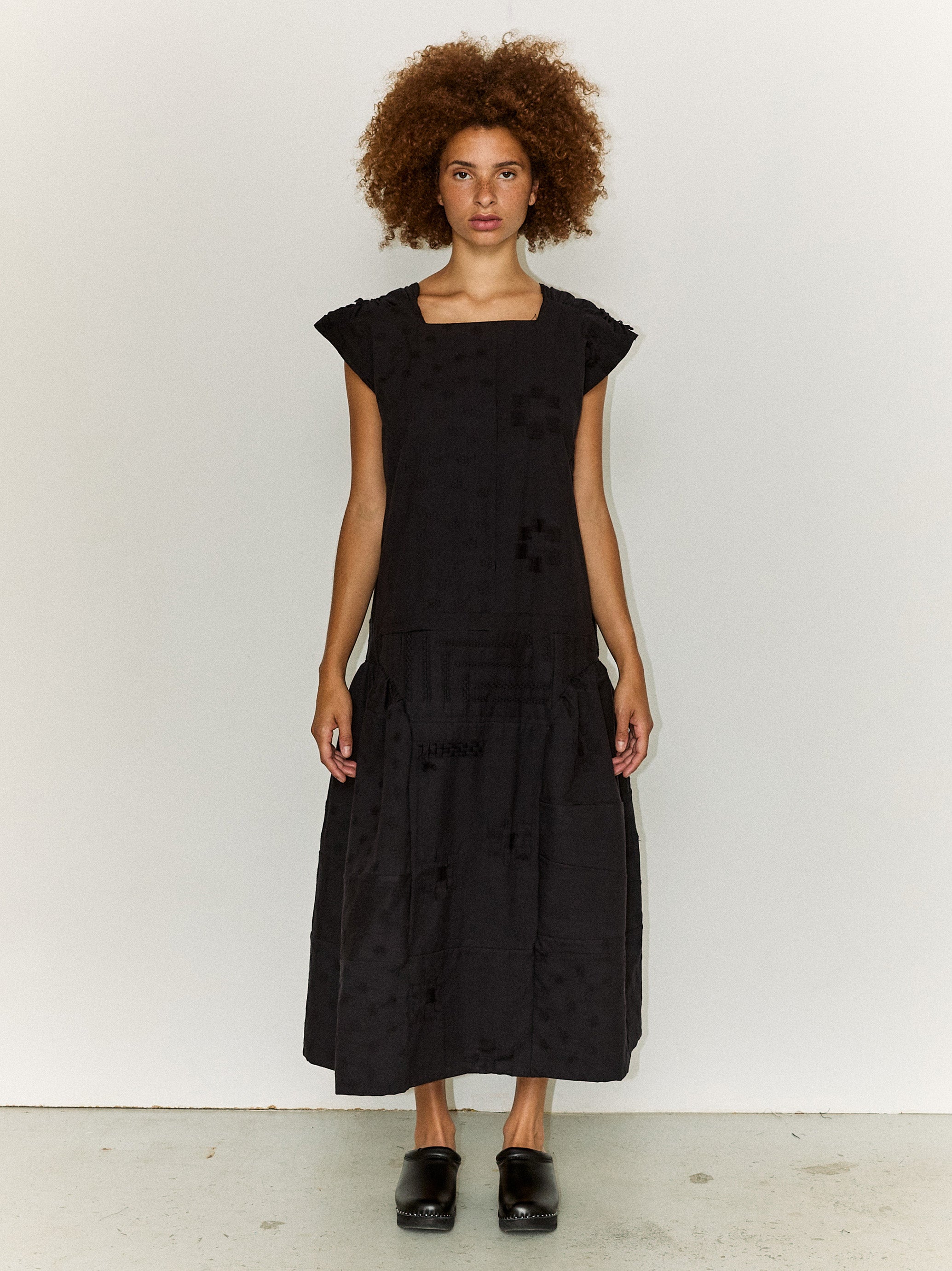 Model wearing the Stem Patchwork Dress in black, front view
