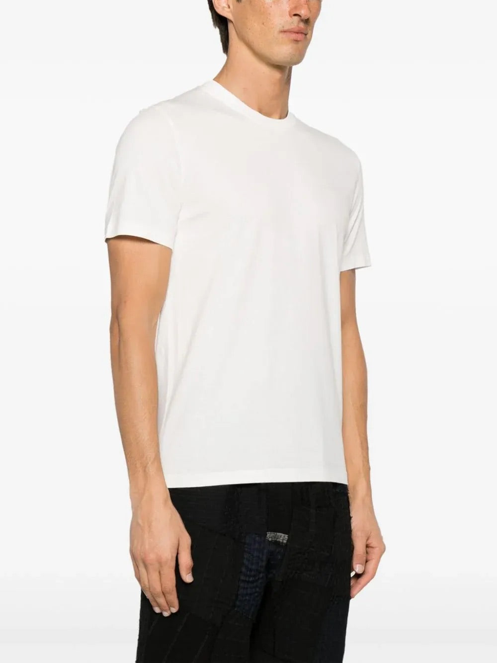 Side view of the Maison Margiela Snow T-shirt on a model, highlighting its clean silhouette and straight fit.