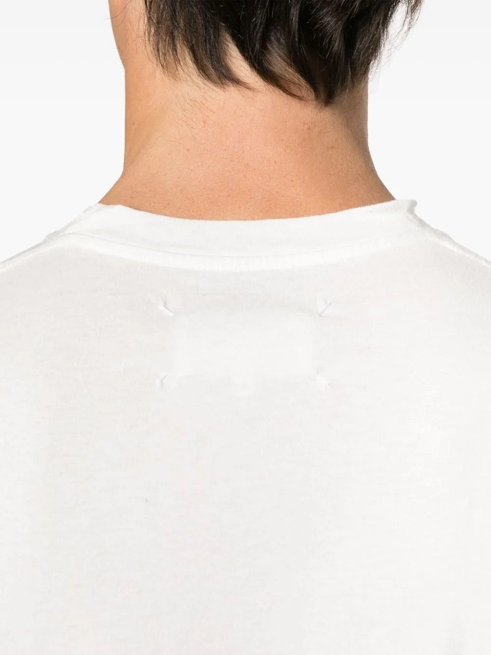 Close-up of the back neckline of the Maison Margiela Snow T-shirt, showcasing the brand’s iconic four-stitch signature.