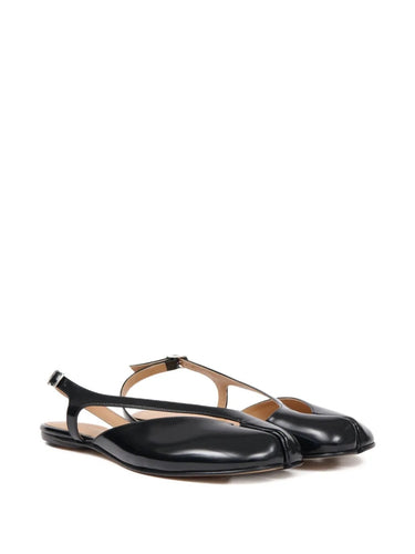 Diagonal front packshot of the Maison Margiela Tabi Flat Slingback in black, highlighting the iconic tabi split toe, smooth calf leather construction, and refined flat silhouette.