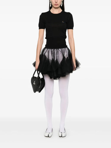 Model wearing Bea Top in Black by Vivienne Westwood, full-length front view of slim-fit black crew neck top with short sleeves and multicolour Orb embroidery, Spring/Summer 2026