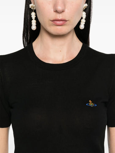 Model wearing Bea Top in Black by Vivienne Westwood, closeup of crew neck and chest area highlighting multicolour Orb logo embroidery, ribbed neckline and slim fit, Spring/Summer 2026