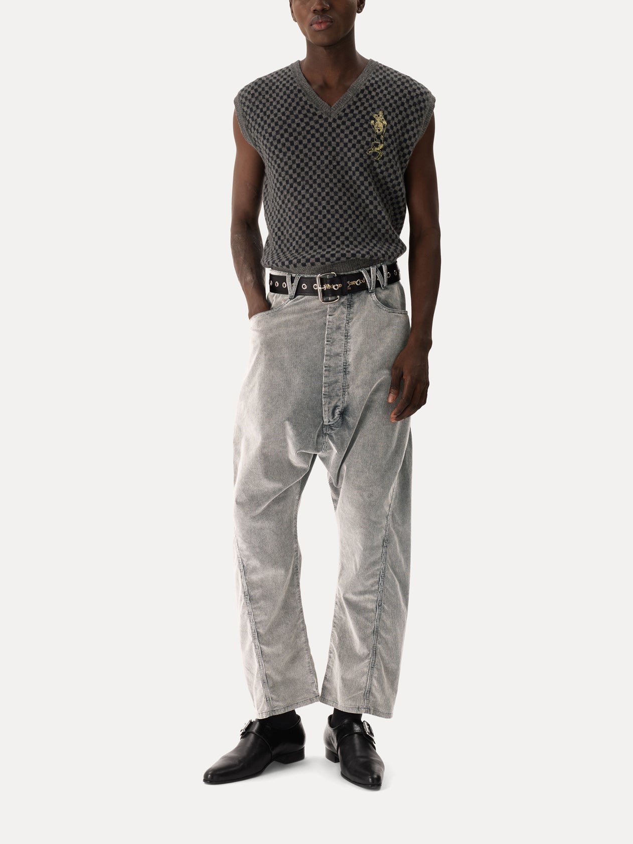 Model wearing Vivienne Westwood Checkmate Vest in grey melange and navy check with sleeveless silhouette, deep V-neck and relaxed fit